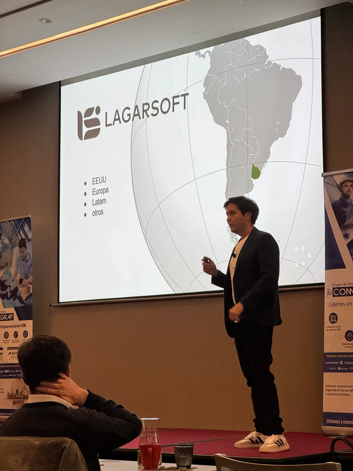 Lagarsoft engineer presenting at a regional industry event, with a slide showing the Lagarsoft logo over a map of South America and Uruguay highlighted
